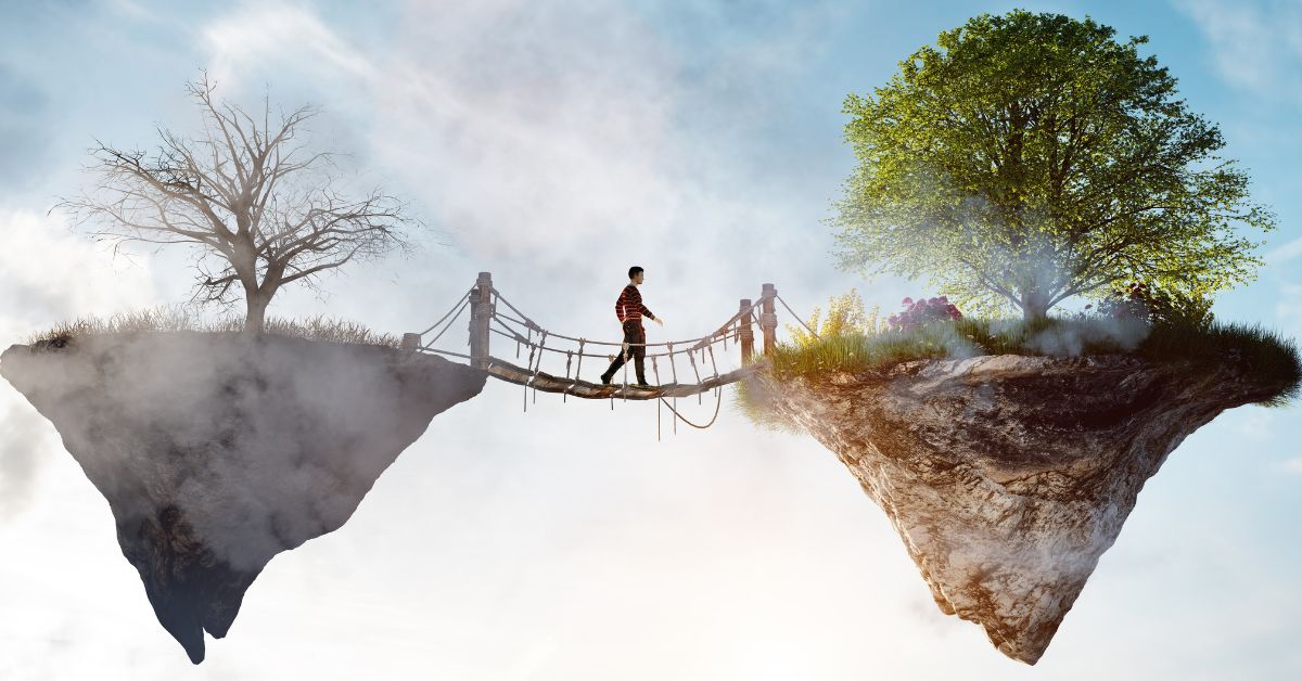 Man walking from a dull floating stone to a vibrant floating stone via a rope bridge.