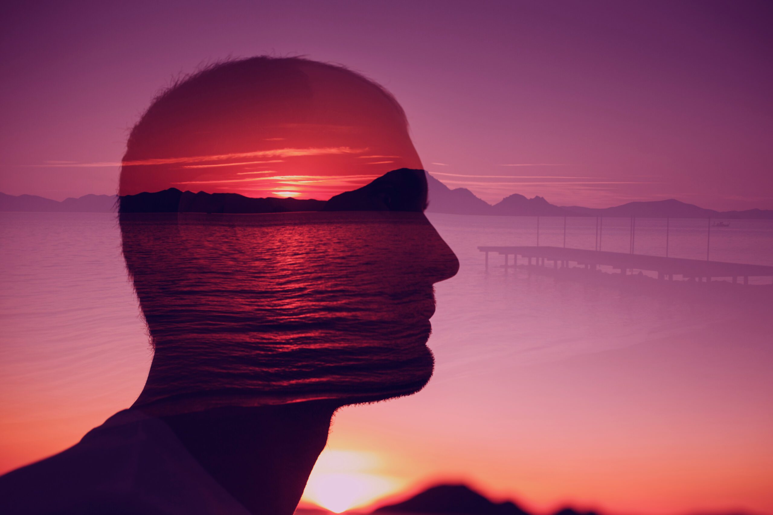 man looking over peaceful sunset