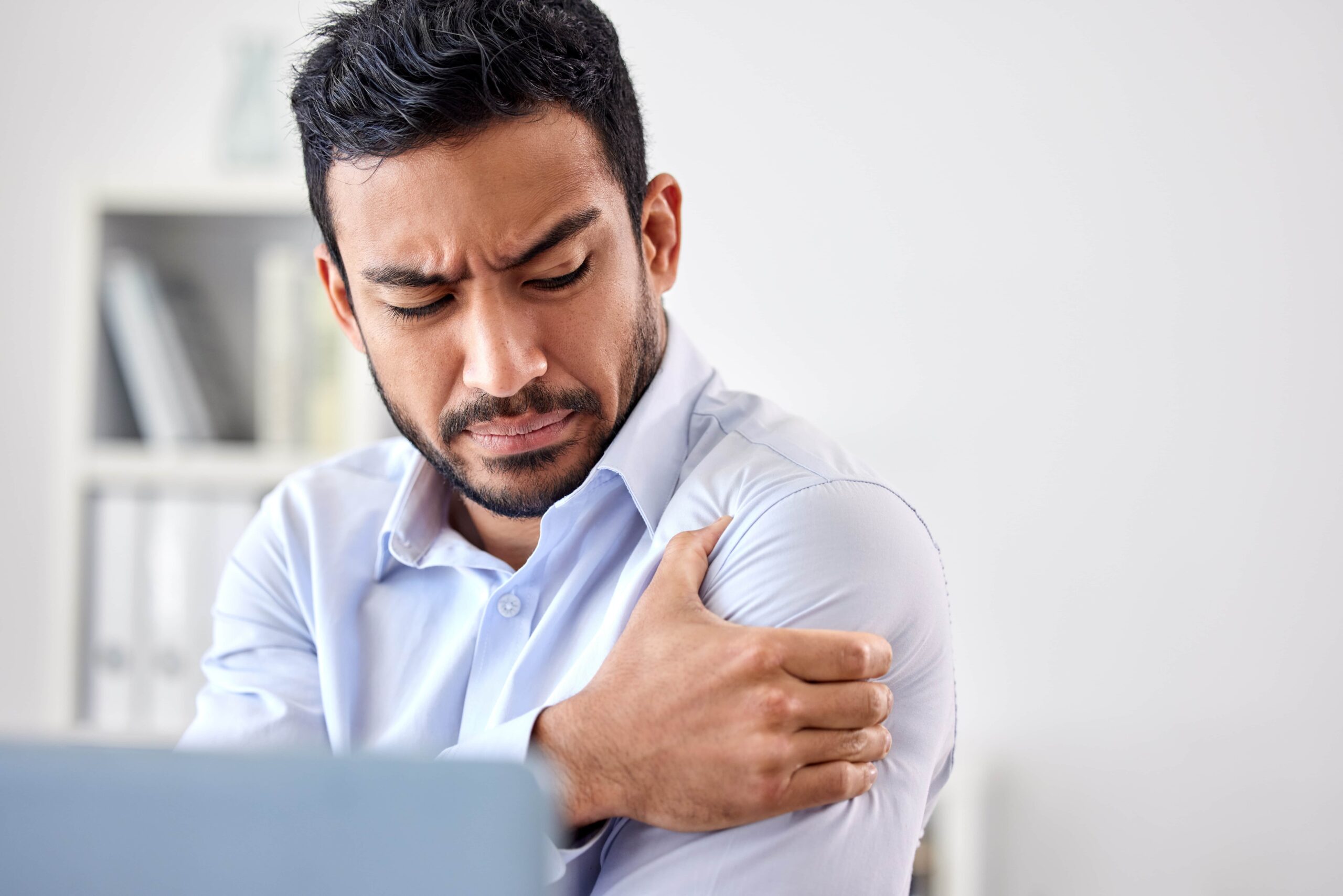 a man with emotional and shoulder pain